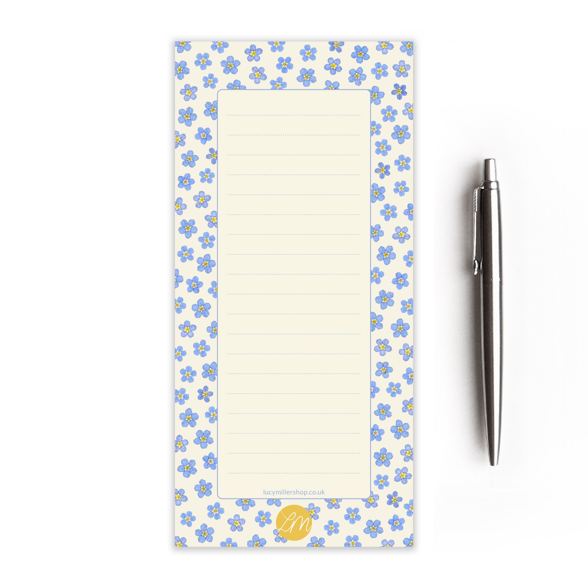 Pressed forget-me-not patterned notepad with a pen on a white background