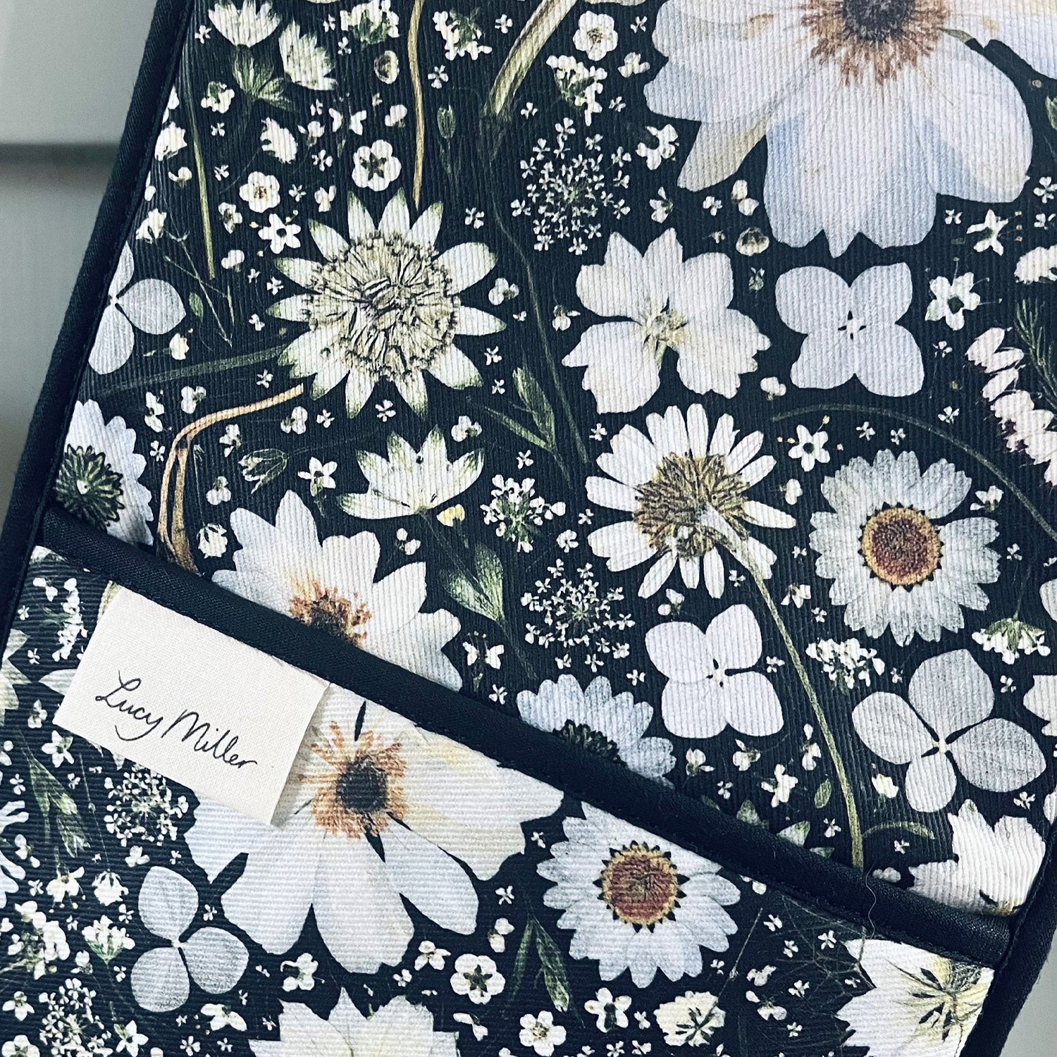 Close up of the printed pressed flowers which make up this unique design on Lucy Miller's Pressed Floral kitchen textiles range.
