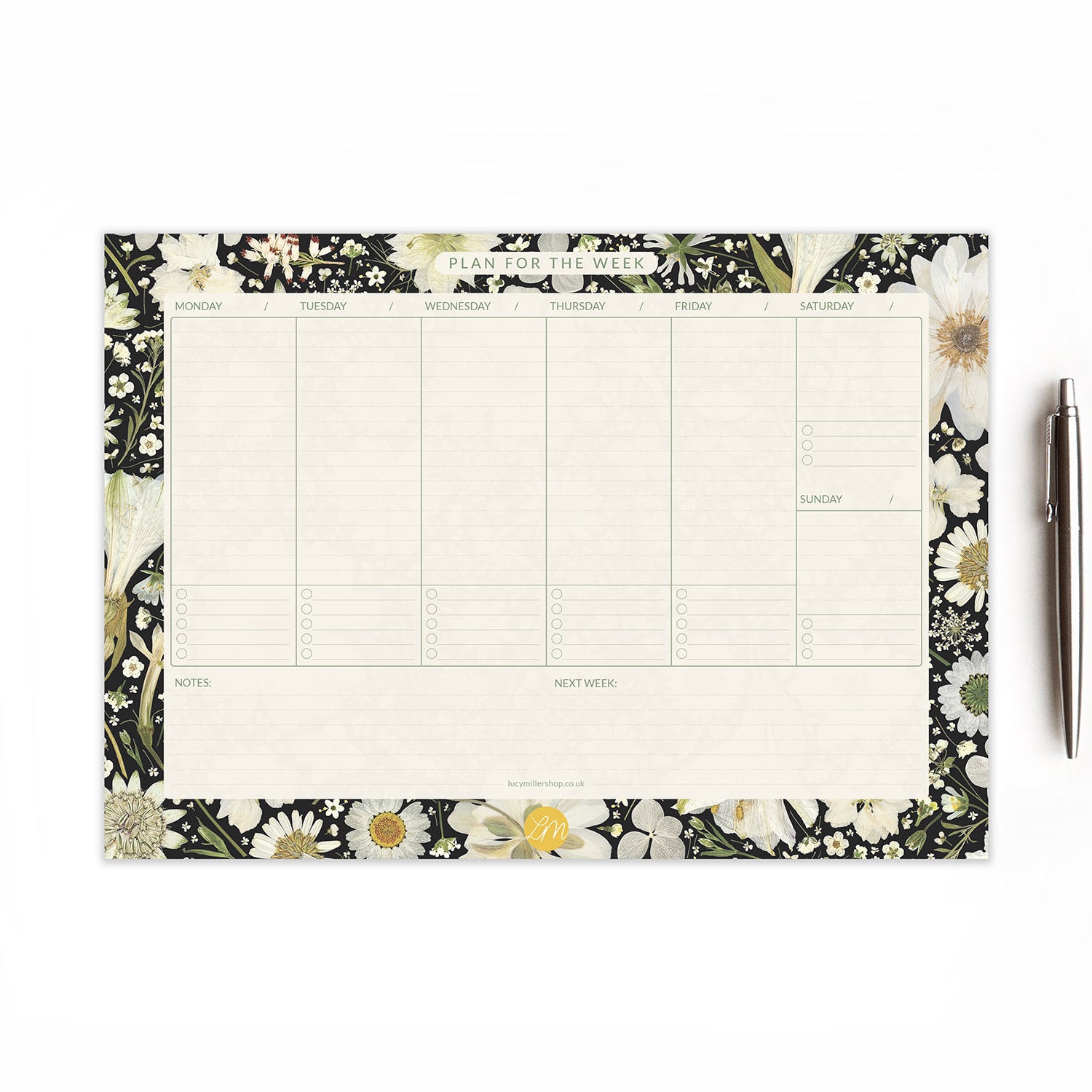 Weekly planner desk pad with pressed white flowers on black background, showing weekday and weekend columns, 'Notes,' and 'Next Week' sections; perfect for busy professionals, students, or home organisation.