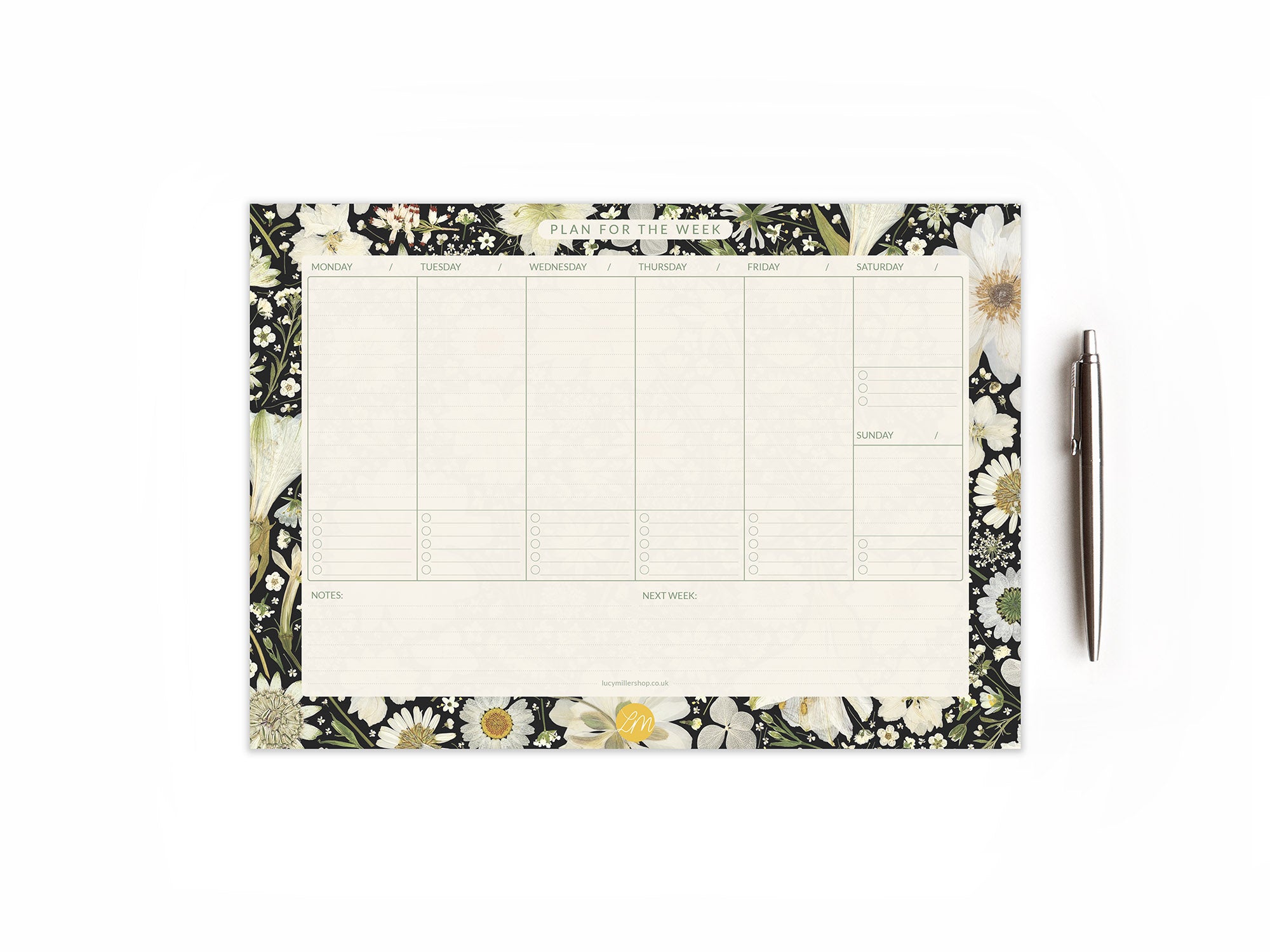 Weekly planner desk pad with pressed white flowers on black background, showing weekday and weekend columns, 'Notes,' and 'Next Week' sections; perfect for busy professionals, students, or home organisation.