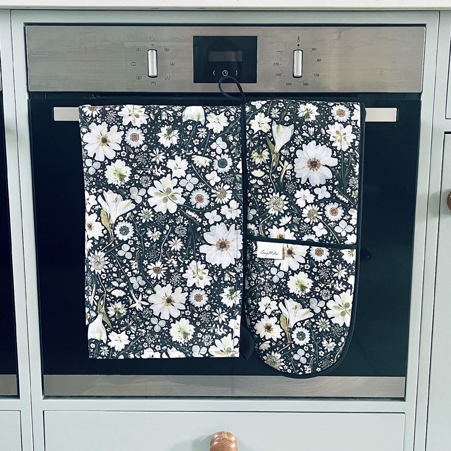 Lucy Miller cotton tea towel and oven gloves featuring a pressed flower design in black and white.