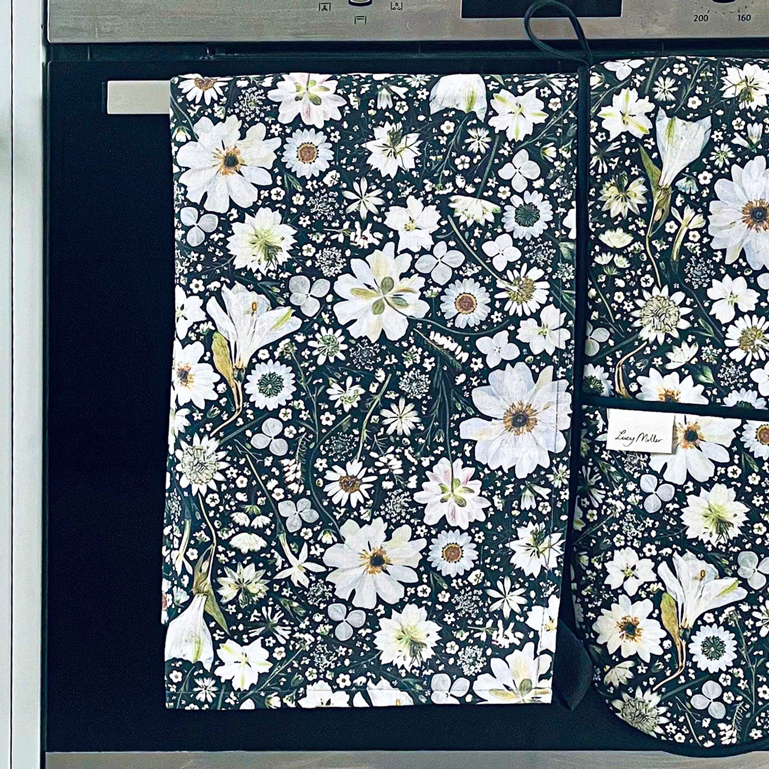 Cotton tea towel with a unique pressed flower design in black and white.