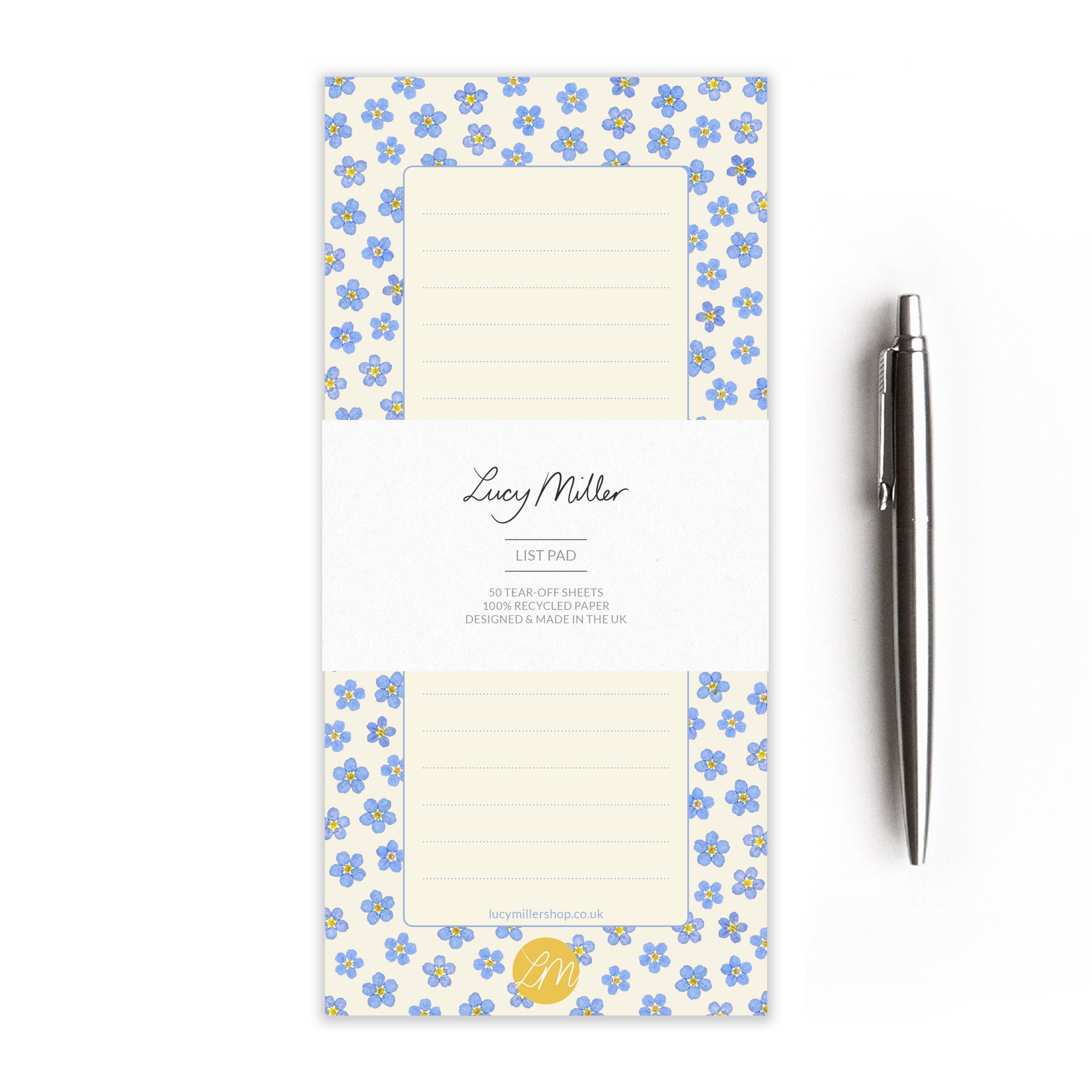 Pressed forget-me-not patterned list pad with a pen on a white background