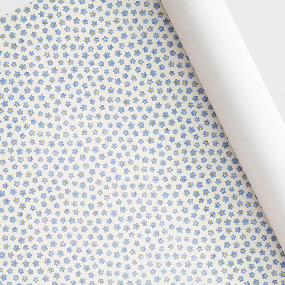 Floral patterned paper with pressed forget-me-not flowers on a white background