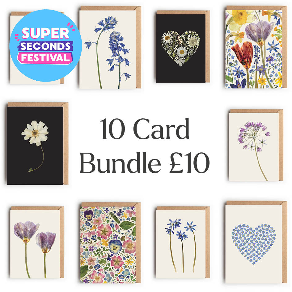 A promotional collage showing a bundle of 10 floral and botanical greeting cards with kraft envelopes, arranged around large text reading '10 Card Bundle £10' and a blue circular badge that says 'SUPER SECONDS FESTIVAL'. The cards feature images of pressed flowers, hearts, and patterned designs on cream, black, and multicolour backgrounds.
